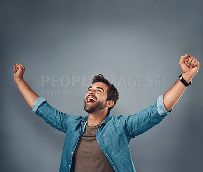 Buy stock photo Happy man, fist and celebration for winning, success or achievement against a grey studio background. Male person screaming in victory, win or accomplishment in motivation for goals on mockup space