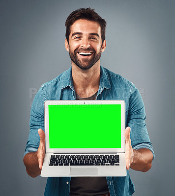 Buy stock photo Happy man, laptop and portrait with mockup green screen for advertising or marketing against grey studio background. Male person showing computer display, chromakey or mock up space for advertisement