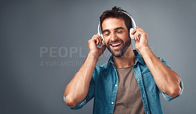 Buy stock photo Studio, man and headphone for music, audio media and podcast or ebook on gray background. Technology, streaming and online subscription for song, male person and smile for listening with mock up