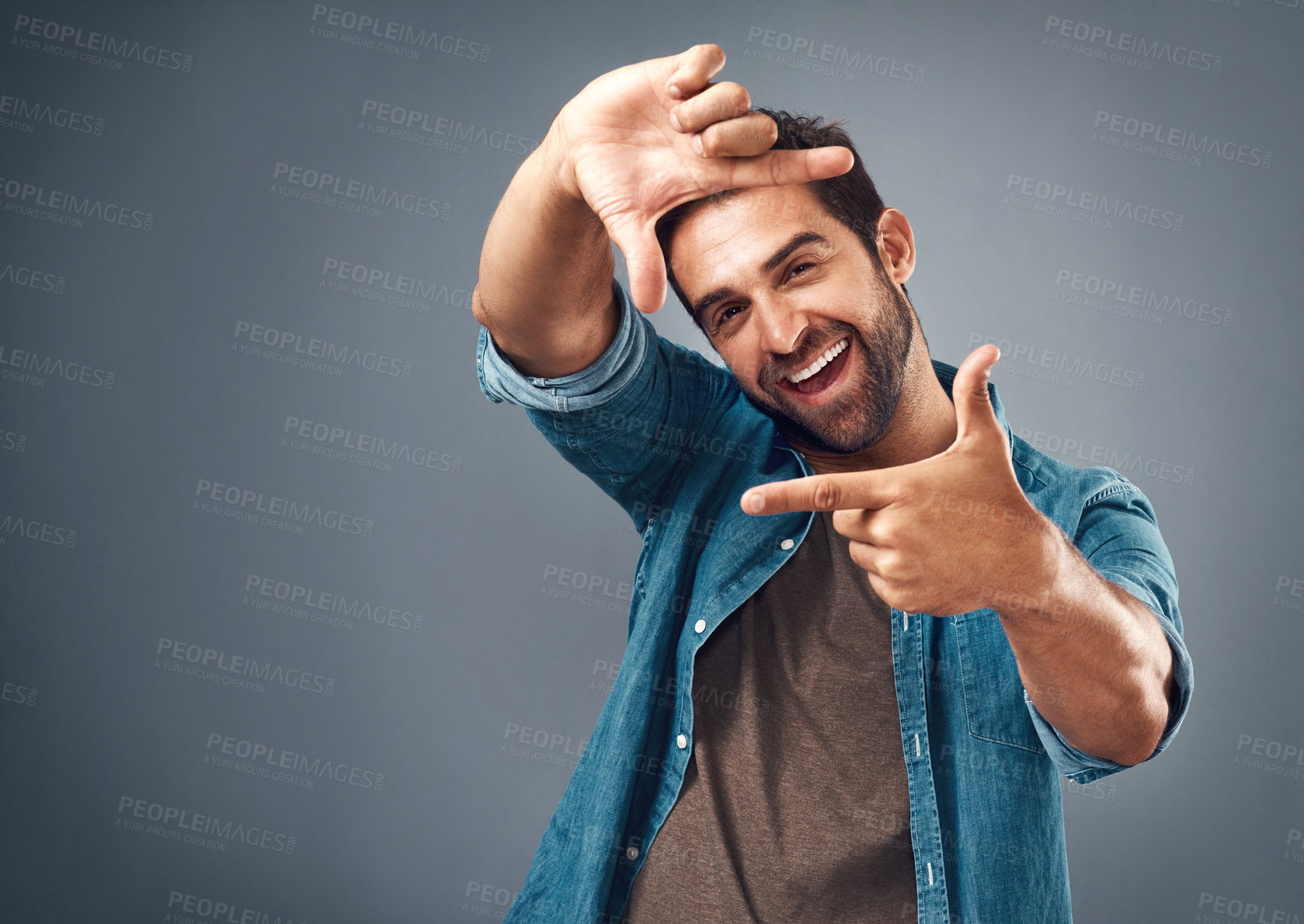 Buy stock photo Frame, excited and portrait of man in studio on gray background with happiness, confident and smile. Finger border, face and happy male person with hand sign for picture, photography and perspective