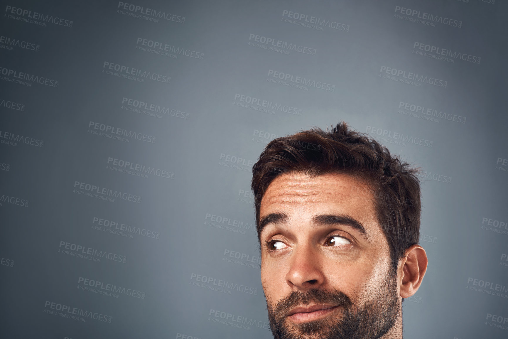 Buy stock photo Happy man, eyes and thinking with choice on mockup space for notification in studio on a gray background. Face of handsome male person or model in wonder or thought for question, solution or ideas