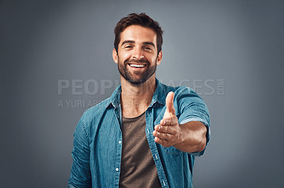 Buy stock photo Happy man, portrait and handshake for introduction, welcome or greeting against a grey studio background. Male person shaking hands with smile for promotion, meeting or deal agreement on mockup space