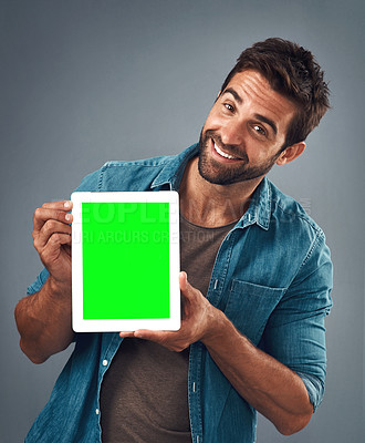 Buy stock photo Happy man, portrait and tablet with green screen for advertising, marketing or branding against a grey studio background. Male person showing technology display, chromakey or mock up in advertisement