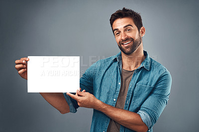 Buy stock photo Happy man, billboard and mockup for advertising, marketing or branding against a grey studio background. Portrait of male person holding rectangle poster, placard or board of empty sign for message
