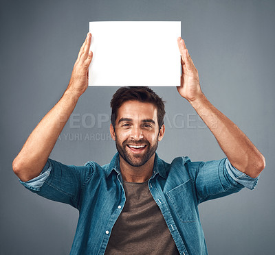 Buy stock photo Happy man, portrait and poster on mockup for advertising, marketing or branding against a grey studio background. Male person holding rectangle billboard or placard for sign, message or advertisement