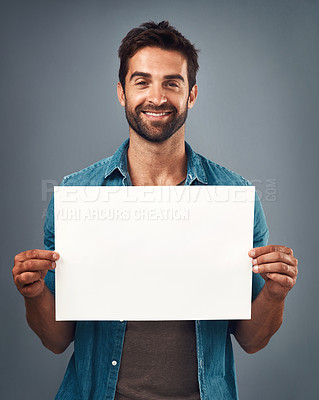 Buy stock photo Happy man, portrait and billboard on mockup for marketing, advertising or branding against a grey studio background. Male person holding rectangle poster or placard for sign, message or advertisement