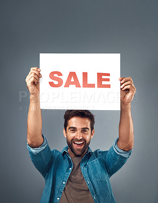 Buy stock photo Happy man, hands and sale sign for advertising, branding or marketing against a grey studio background. Excited male person, surprise holding poster with smile for sales, discount or advertisement