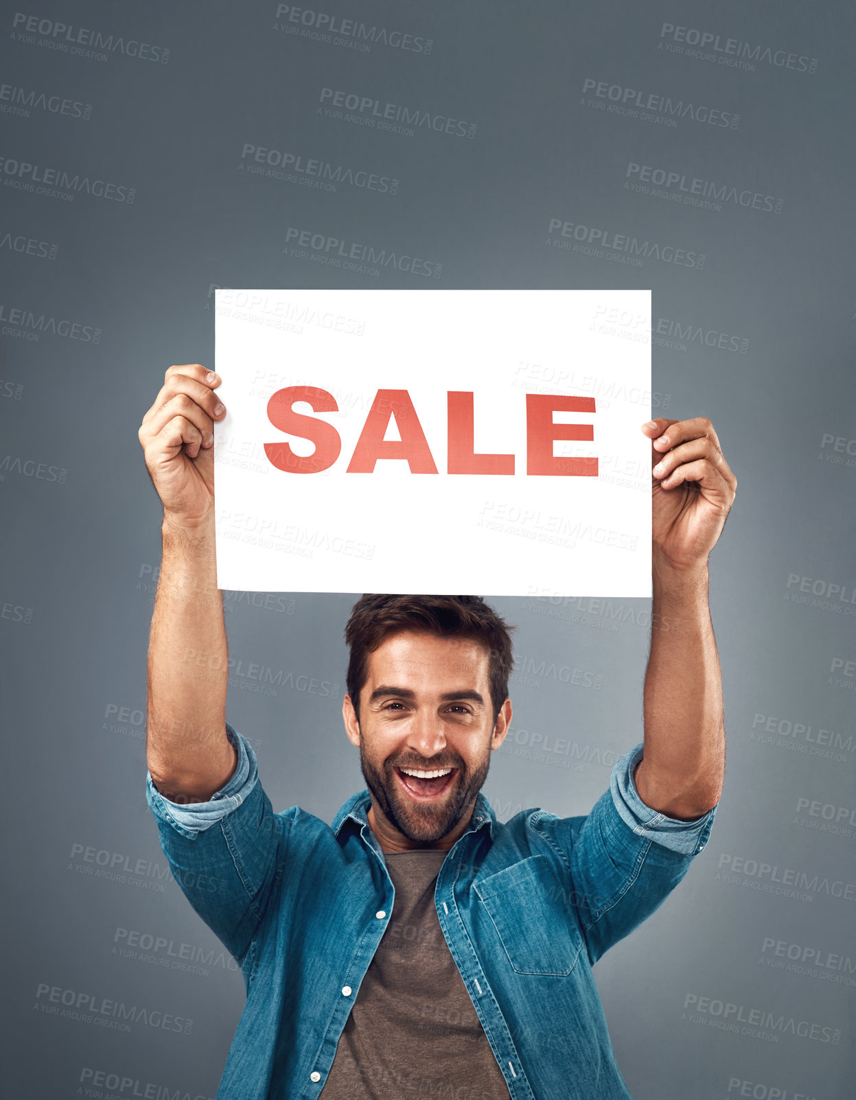 Buy stock photo Happy man, hands and sale sign for advertising, branding or marketing against a grey studio background. Excited male person, surprise holding poster with smile for sales, discount or advertisement