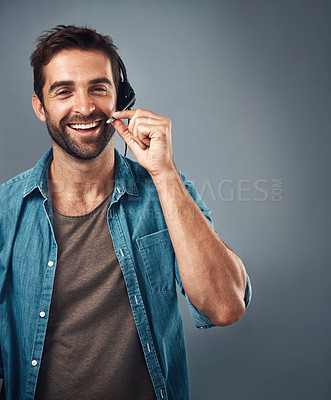Buy stock photo Happy man, call center and headphones of consultant on mockup against a grey studio background. Portrait of friendly male consulting agent smiling with headset mic in contact us for online advice