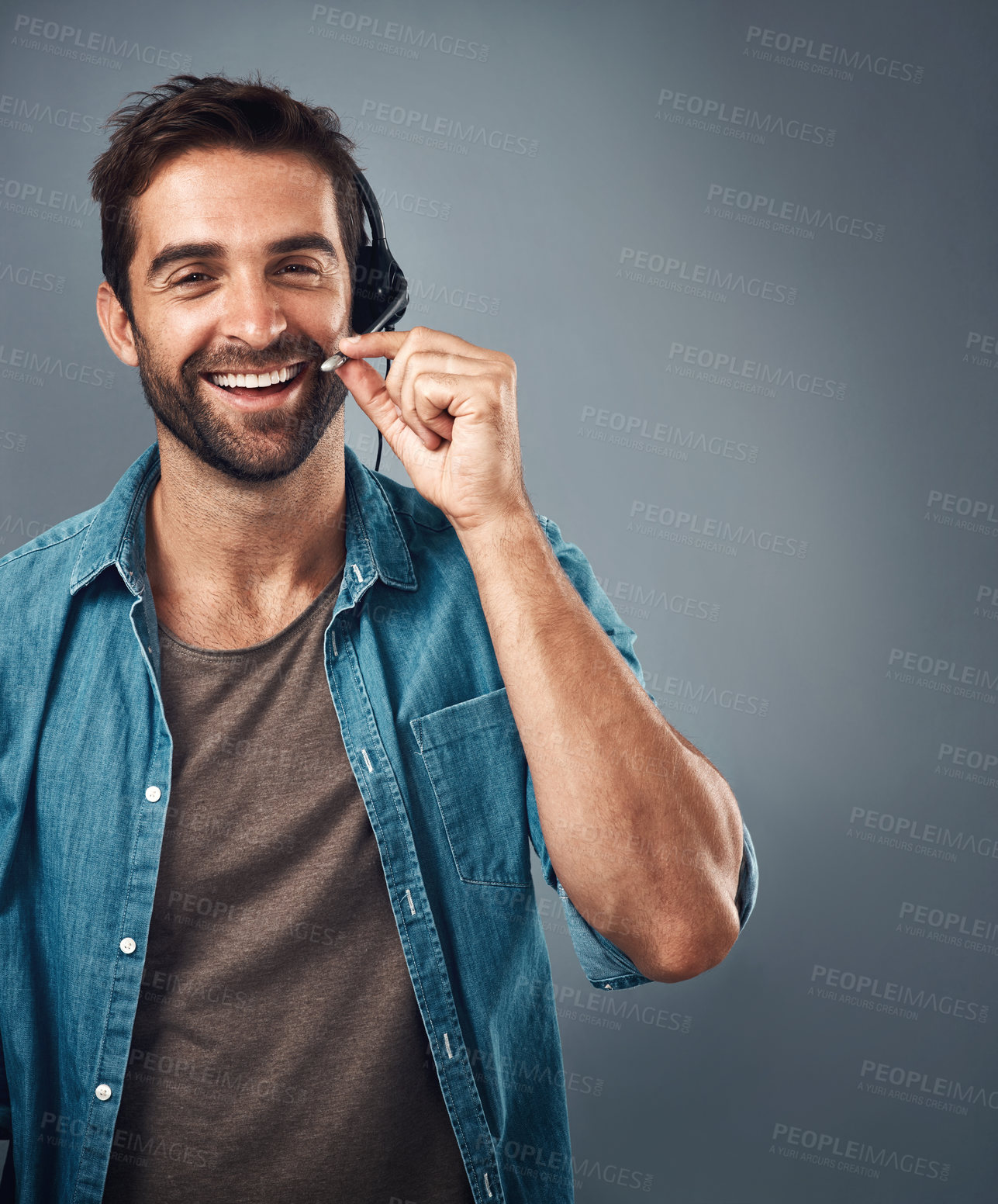 Buy stock photo Happy man, call center and headphones of consultant on mockup against a grey studio background. Portrait of friendly male consulting agent smiling with headset mic in contact us for online advice