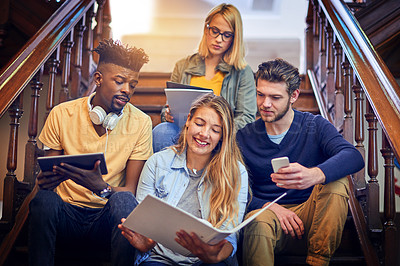 Buy stock photo Cropped shot of a group of diverse university students working together on the staircase on campus
