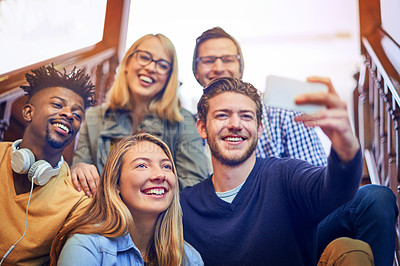 Buy stock photo Cropped shot of a group of diverse university students taking a selfie on the staircase on campus