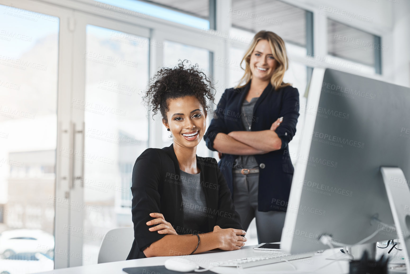 Buy stock photo Portrait of two businesswomen working together in an office