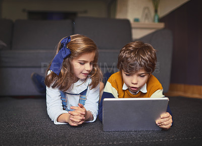 Buy stock photo Tablet, kids and siblings relax on floor for learning, game or reading ebook together in home. Children, brother and sister on digital technology for online education, watch movie or streaming video
