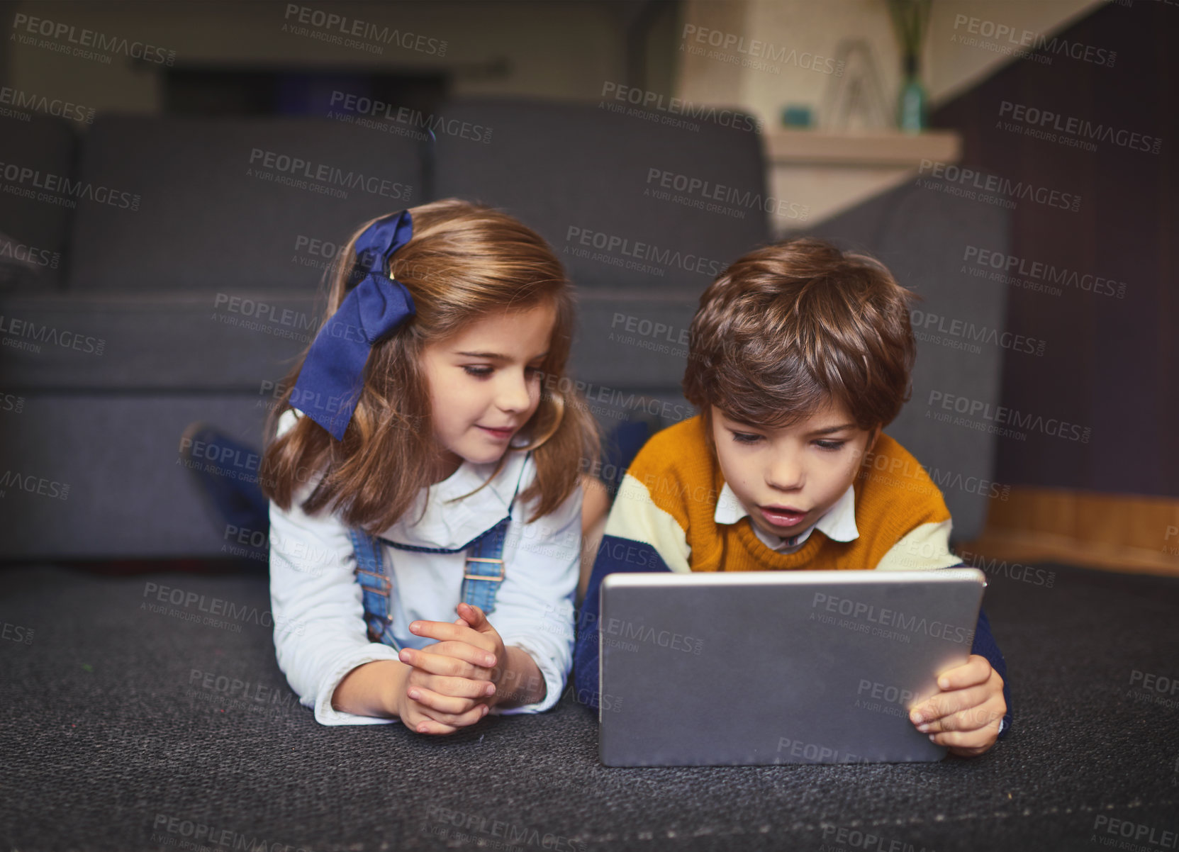 Buy stock photo Shot of adorable little kids using wireless technology at home