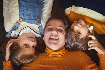 Buy stock photo Cropped shot of a woman lying on the floor with her daughter and son