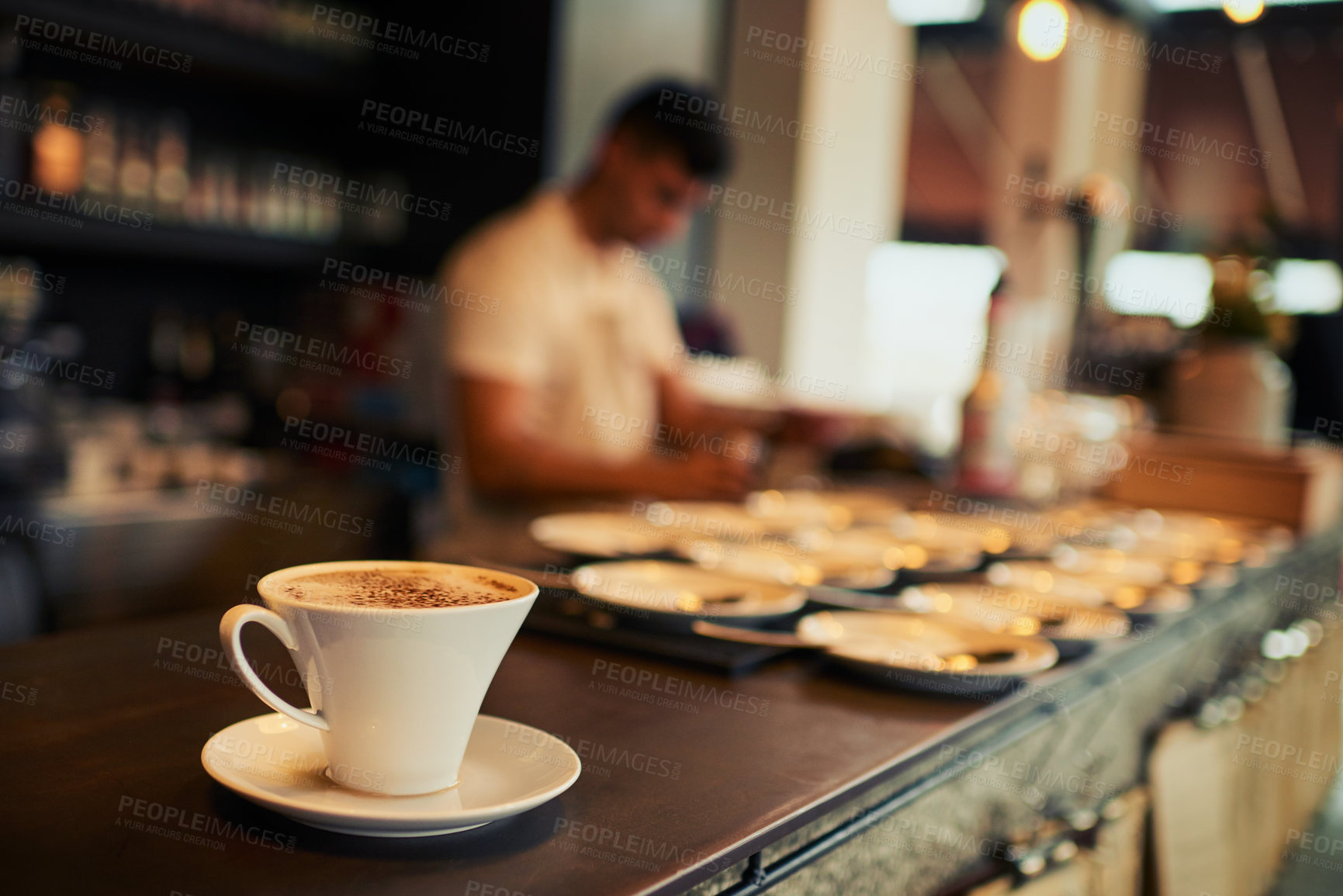Buy stock photo Shot of a freshly brewed cup of coffee standing on a table by it's own inside of a restaurant during the day