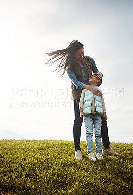 Buy stock photo Shot of a mother embracing her daughter from behind