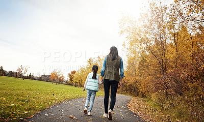 Buy stock photo Mom, back and holding hands with child for walk, bonding or outdoor adventure on journey in nature. Rear view of mother strolling with daughter, kid or little girl for sidewalk, autumn season or park