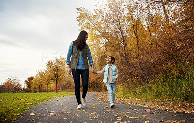 Buy stock photo Shot of a mother and her little daughter enjoying a walk outdoors