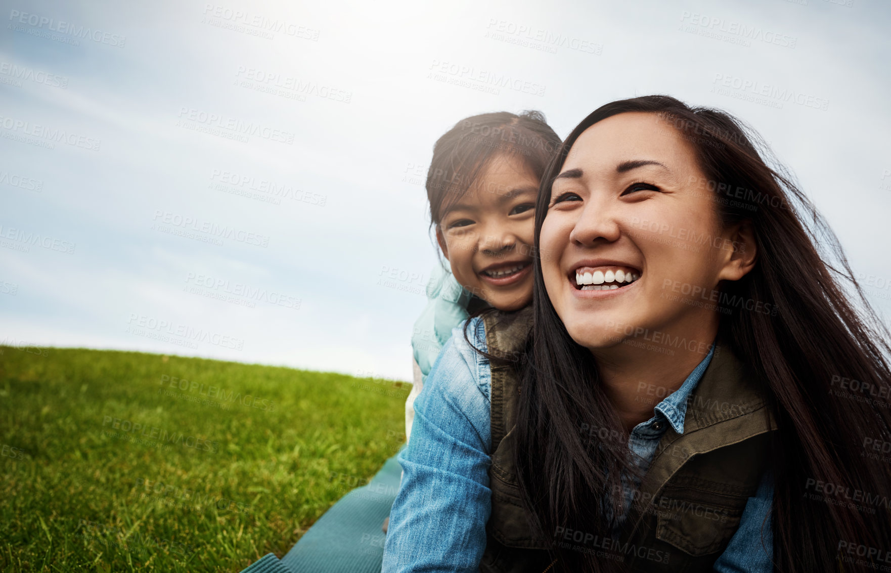 Buy stock photo Cropped shot of a little girl embracing her mother from behind