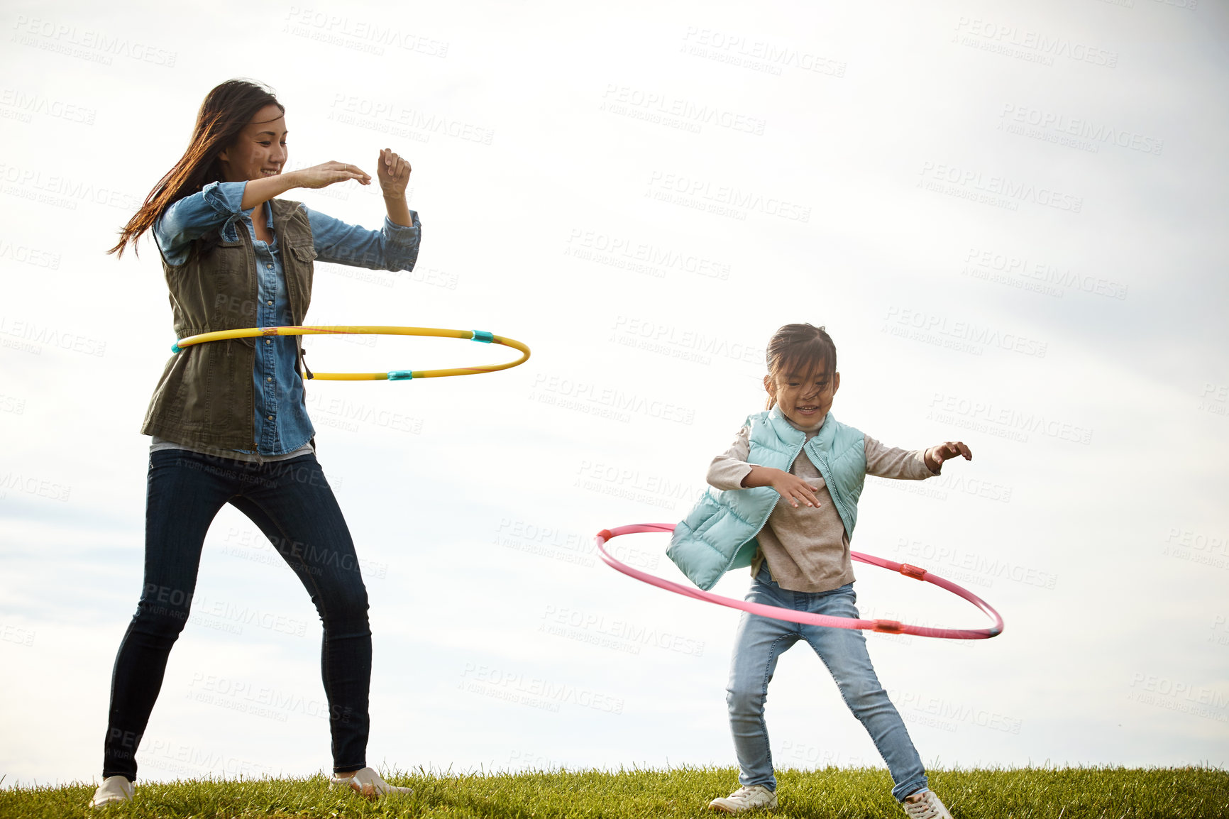 Buy stock photo Mother, girl and fun with hoop in field, toys and nature in autumn for activity. Daughter, together and bonding with female person or mom with child, outdoor and smile for holiday in park for game