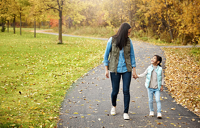 Buy stock photo Shot of a mother and her little daughter enjoying a walk outdoors