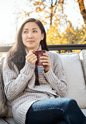Buy stock photo Shot of an attractive young woman having a relaxing coffee break on an autumn day in a garden