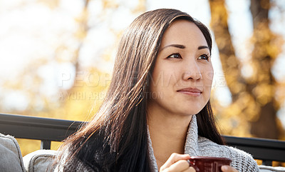 Buy stock photo Shot of an attractive young woman having a relaxing coffee break on an autumn day in a garden