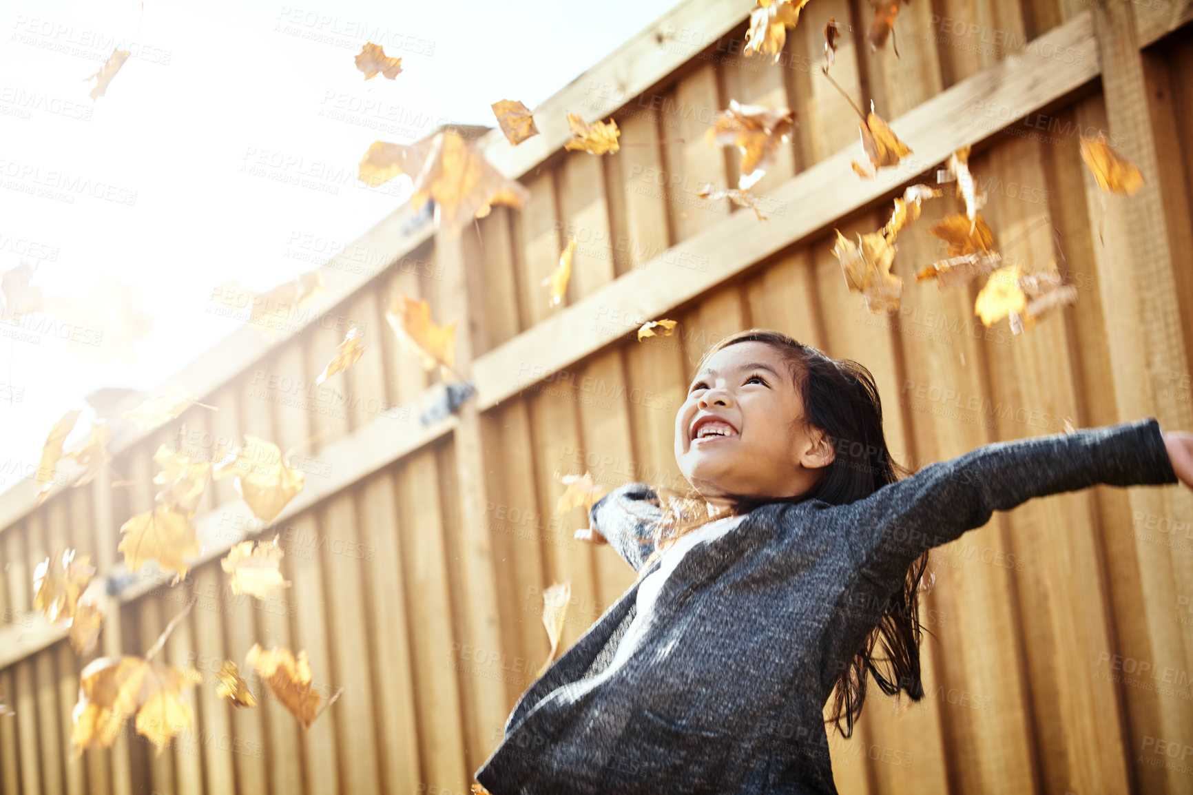 Buy stock photo Shot of an adorable little girl enjoying an autumn day outdoors