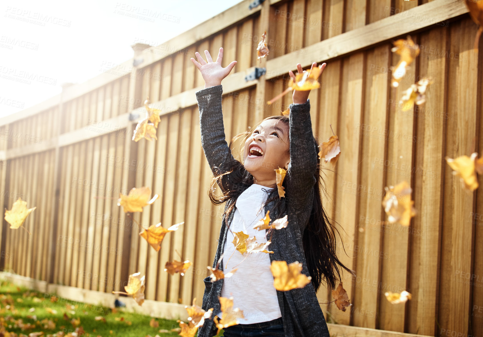 Buy stock photo Shot of an adorable little girl enjoying an autumn day outdoors