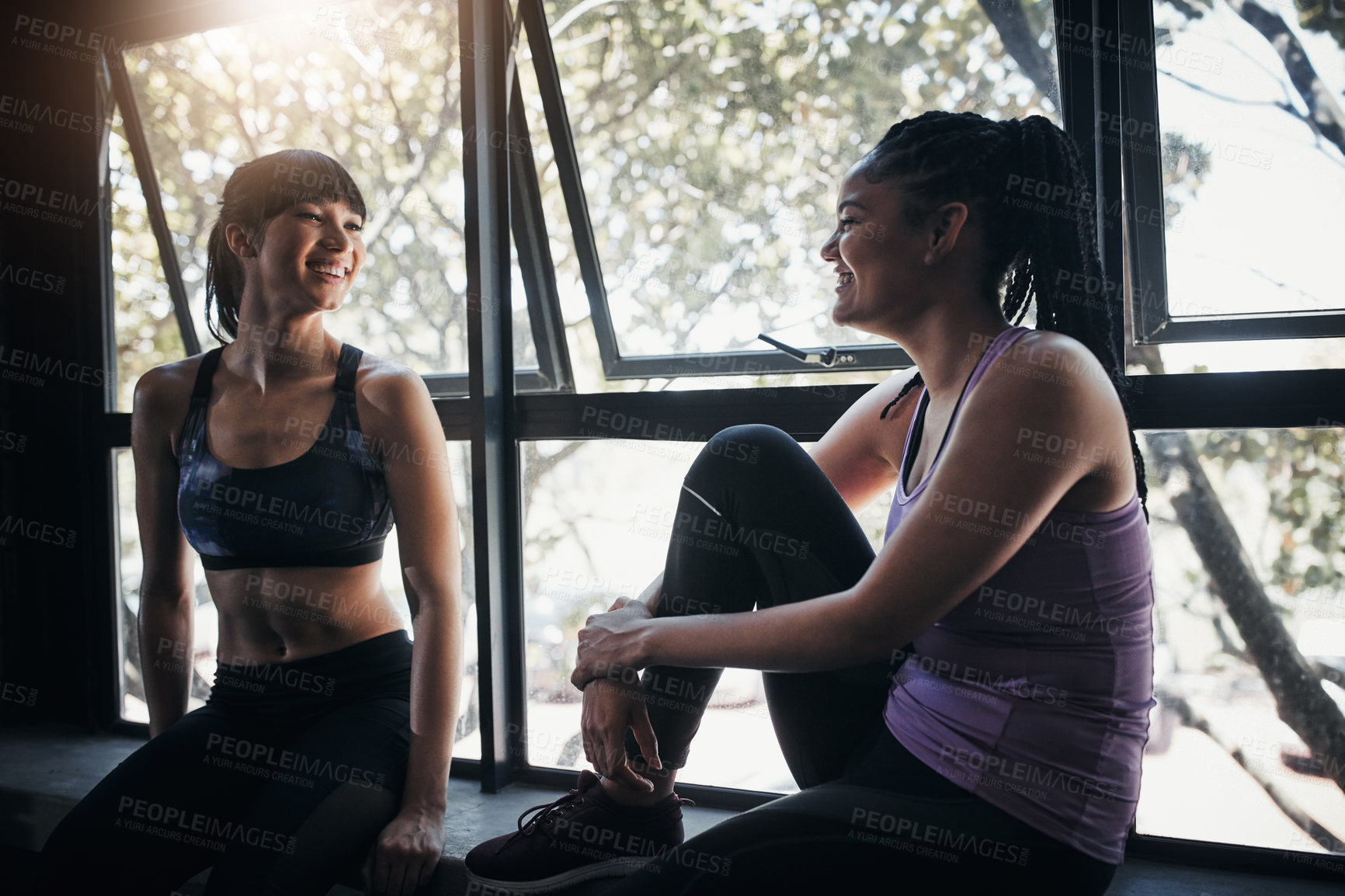 Buy stock photo Shot of two friends chatting while out for a workout at the gym