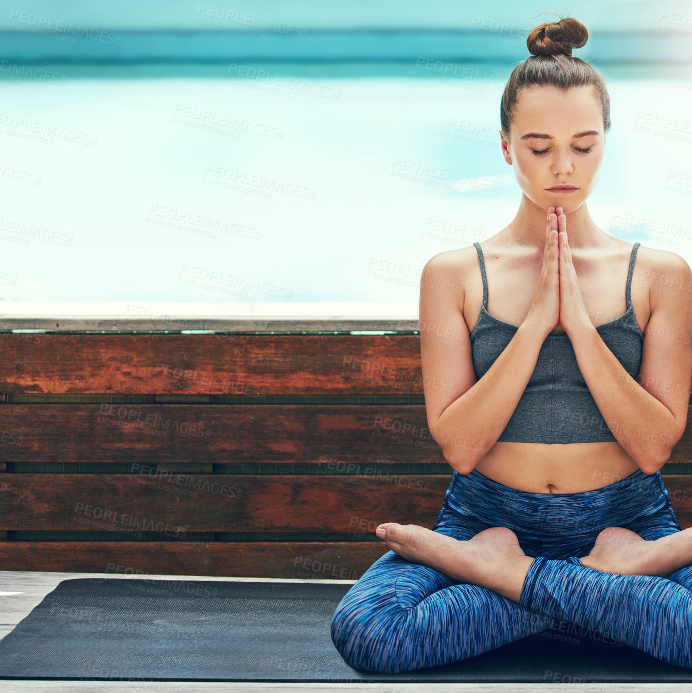 Buy stock photo Cropped shot of a beautiful young woman practicing yoga outside
