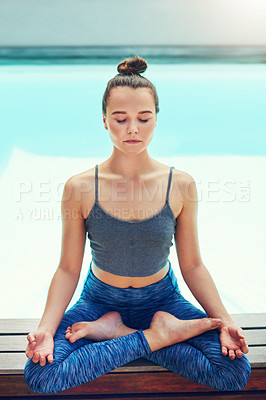 Buy stock photo Shot of a beautiful young woman practicing yoga outside