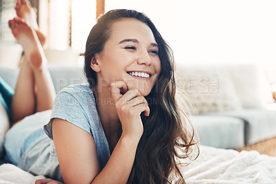 Buy stock photo Shot of an attractive young woman spending a relaxing day on her bed at home