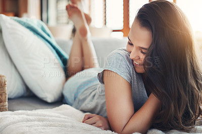 Buy stock photo Shot of an attractive young woman spending a relaxing day on her bed at home
