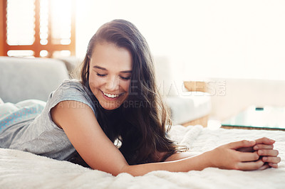Buy stock photo Shot of an attractive young woman spending a relaxing day on her bed at home