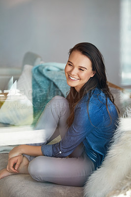 Buy stock photo Shot of an attractive young woman spending a relaxing day on the sofa at home