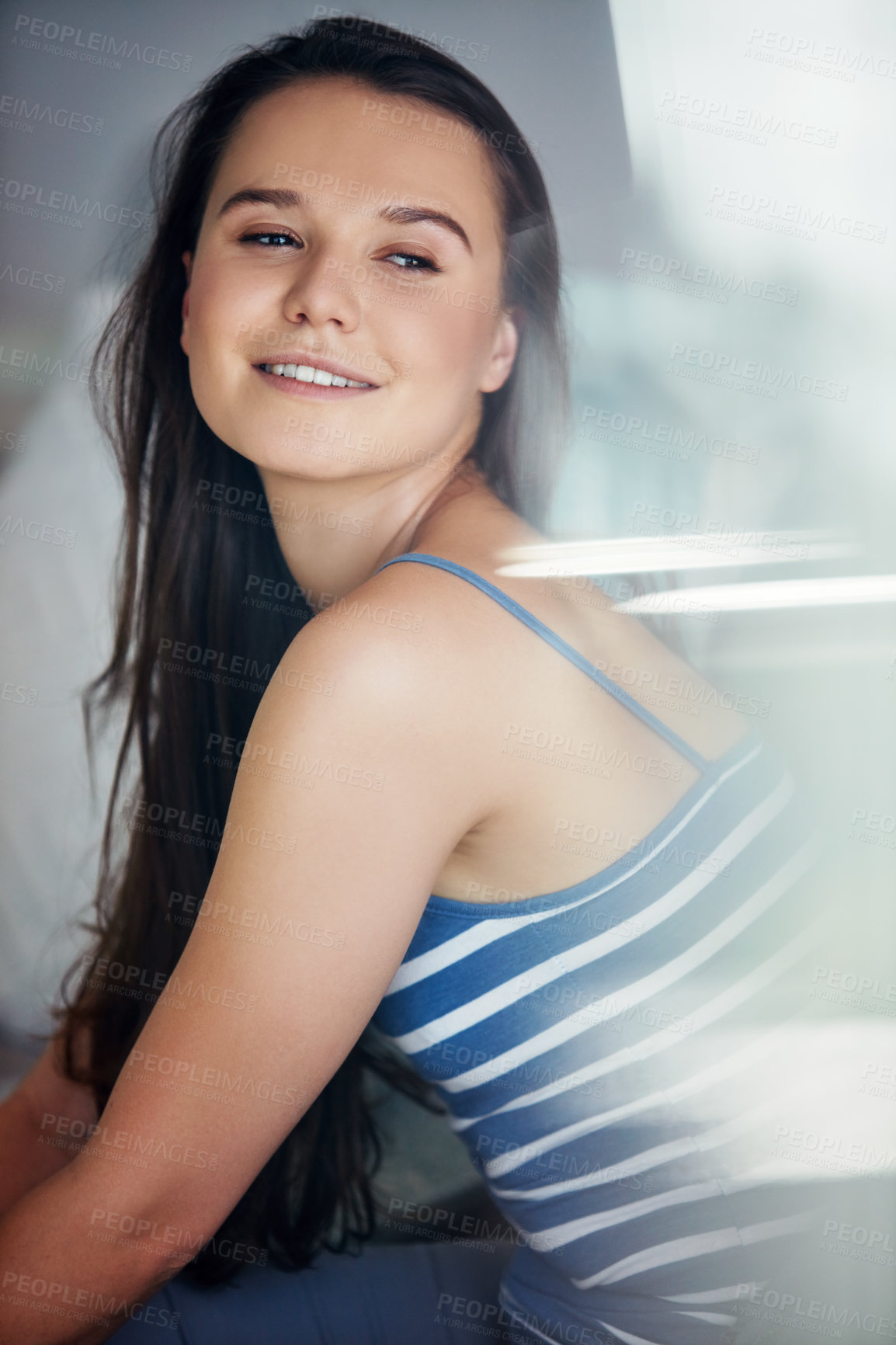 Buy stock photo Shot of an attractive young woman spending a relaxing day on the sofa at home