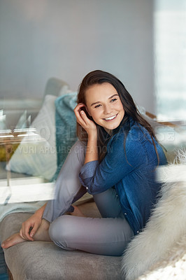 Buy stock photo Shot of an attractive young woman spending a relaxing day on the sofa at home