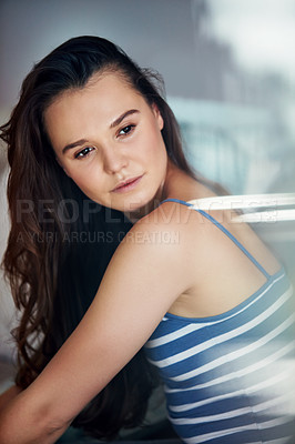 Buy stock photo Shot of an attractive young woman spending a relaxing day on the sofa at home