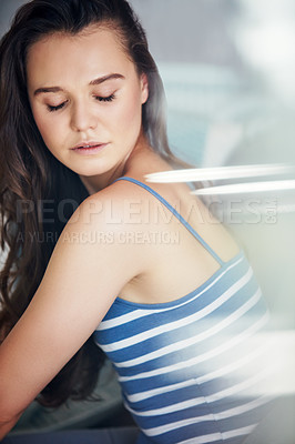 Buy stock photo Shot of an attractive young woman spending a relaxing day on the sofa at home