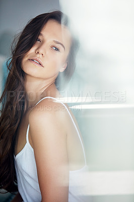 Buy stock photo Shot of an attractive young woman spending a relaxing day on the sofa at home