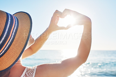 Buy stock photo Rearview shot of an unrecognizable woman spending the day at the beach