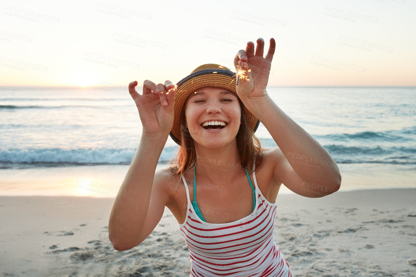 Buy stock photo Holiday, woman and laughing with sparklers on beach for celebration, summer travel and vacation. Portrait, person and happy with fireworks at seaside for special event, funny getaway or weekend break