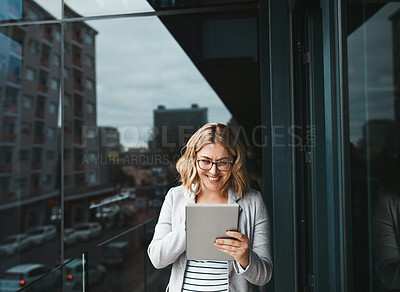 Buy stock photo Shot of a young businesswoman using a digital tablet on the office balcony