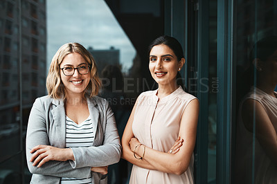 Buy stock photo Portrait of two young businesswoman standing on the office balcony