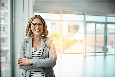 Buy stock photo Portrait of a confident young businesswoman standing in an office
