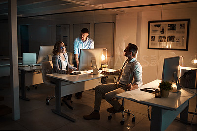 Buy stock photo Shot of a group of businesspeople working late in an office