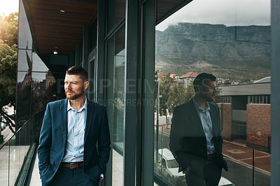 Buy stock photo Shot of a mature businessman standing on the office balcony
